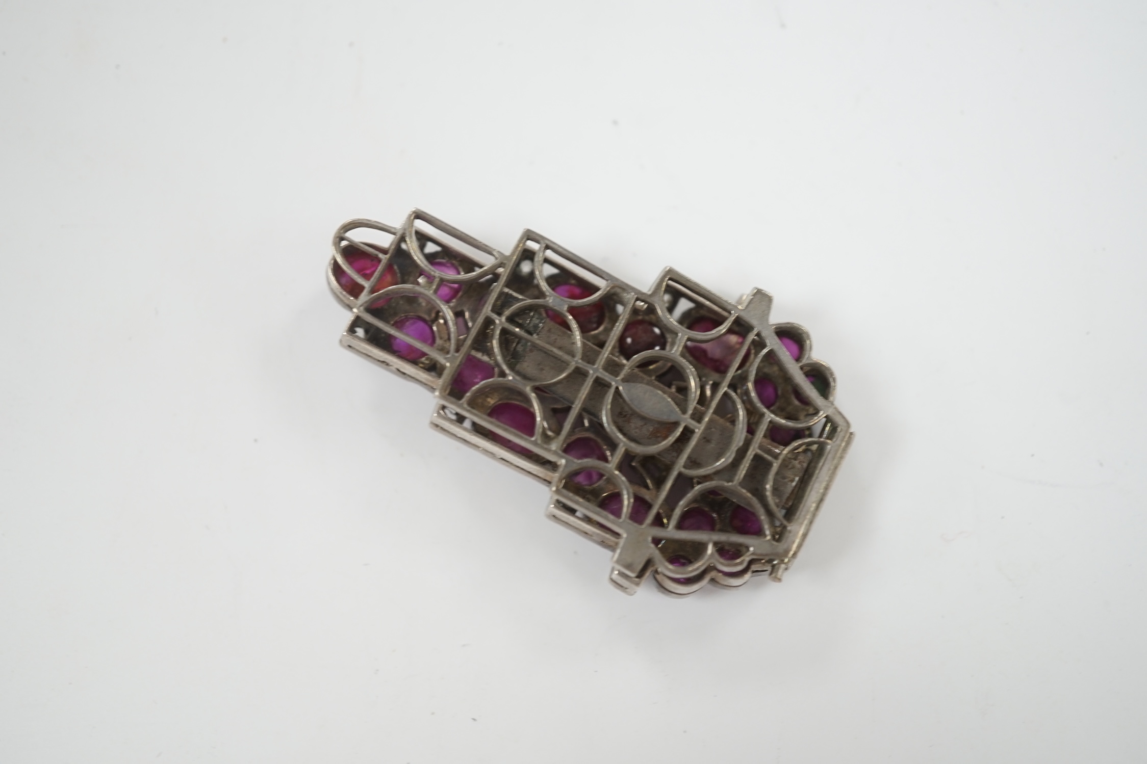 A 1920's? continental white metal cabochon ruby and rose cut diamond set clip brooch, 49mm.